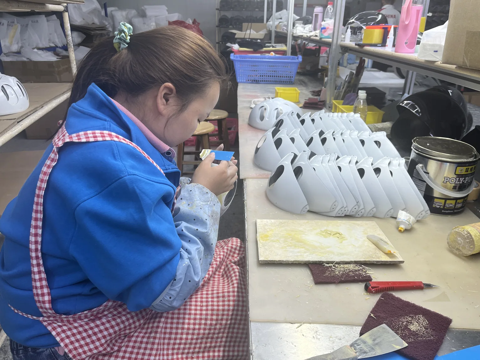 Operator spraying finish onto a manufactured composite component